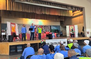 A holiday talent show people performing on a stage.