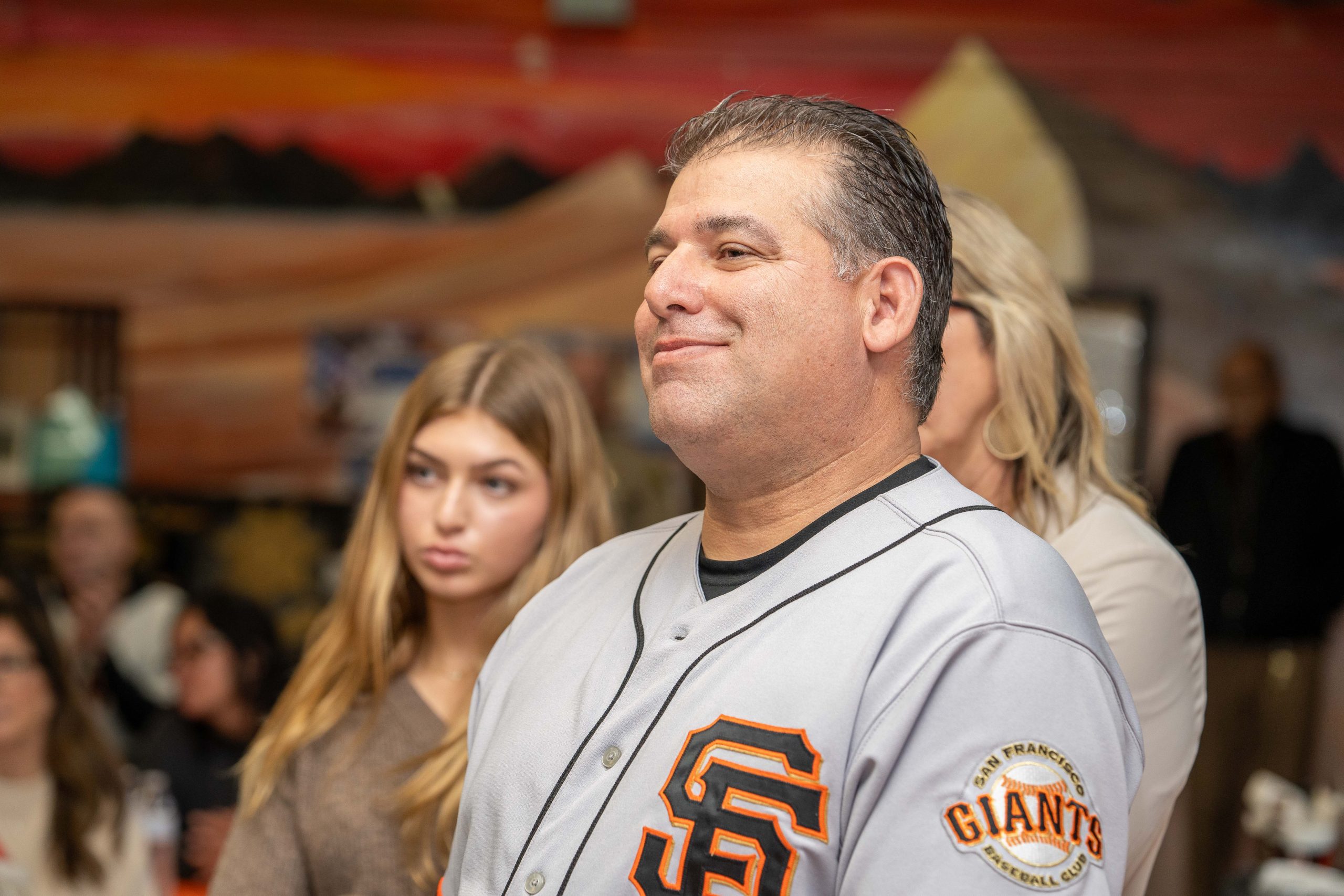 CMF Warden Daniel Cueva wearing a San Francisco Giants baseball jersey at his retirement party.