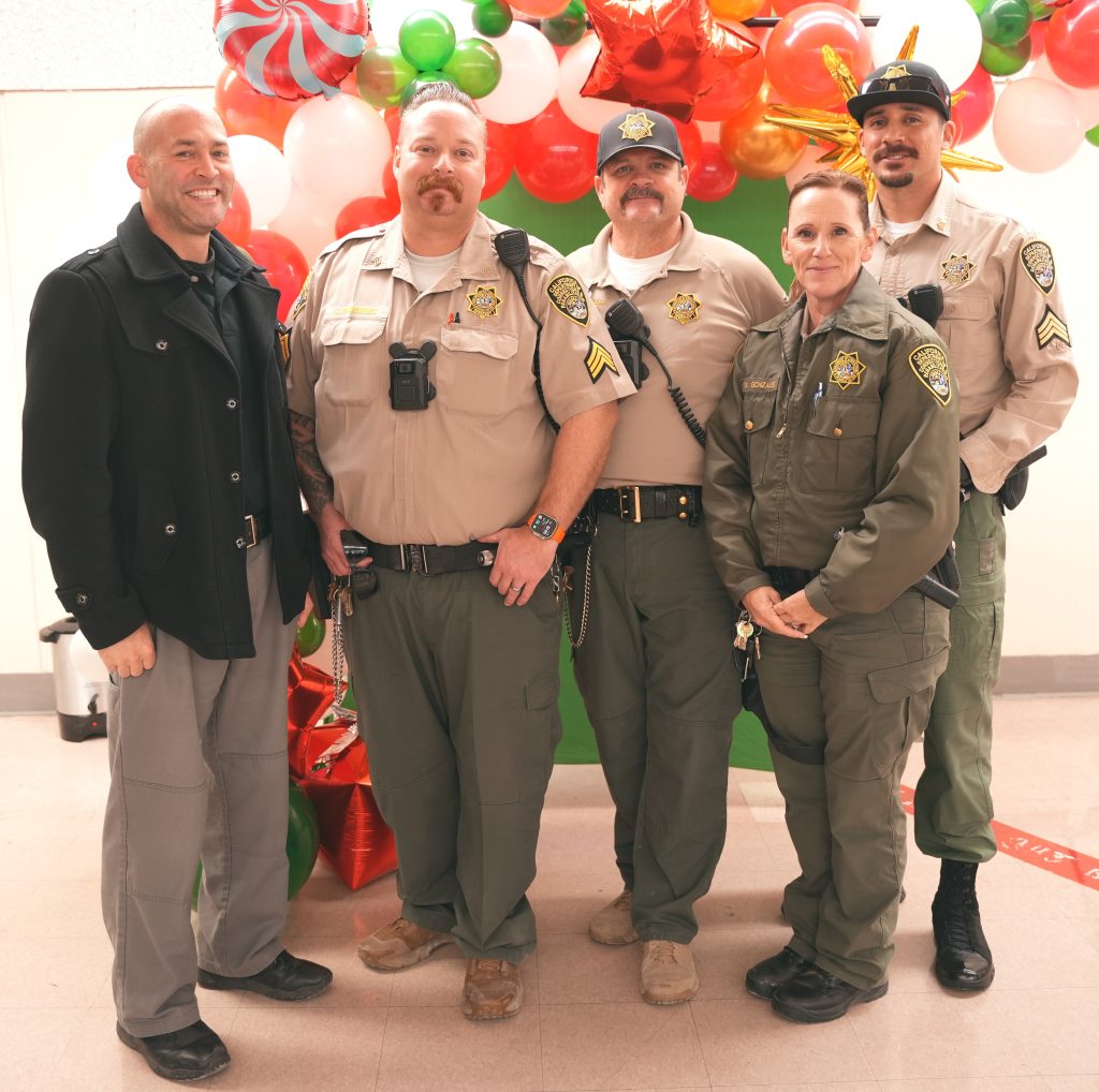 Corcoran staff at a holiday gathering celebration shows four uniformed staff and one wearing plain clothes.