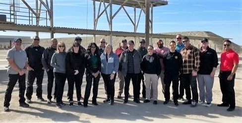Group photo of Corcoran prison management training at a range.