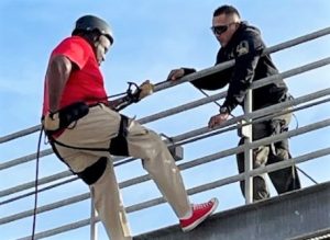 California State Prison management team with a person on a rope course during AOD training.