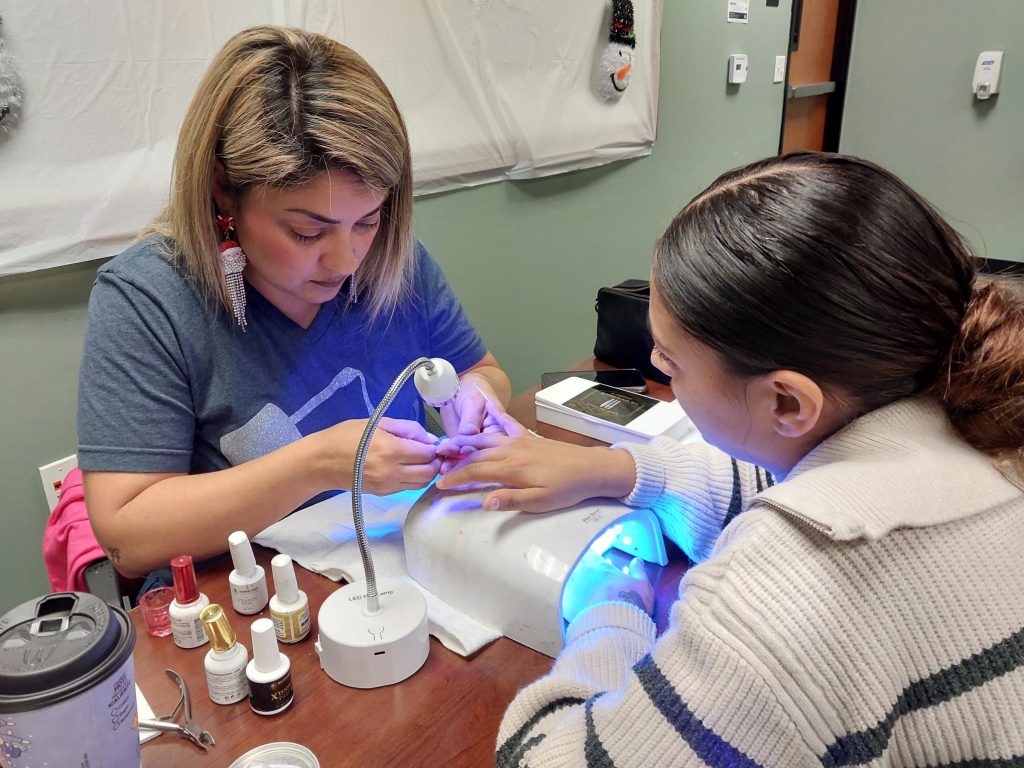 Nail technician works on a supervised person.
