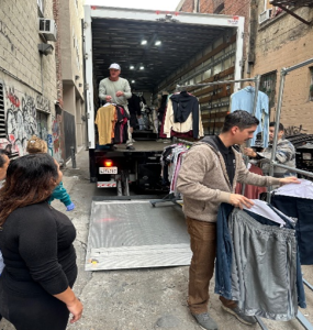 people passing out clothing items