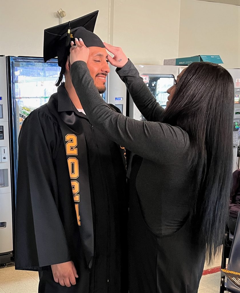 woman adjusting cap on LAC grad