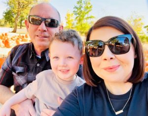 Warden Covello with his wife and young child.