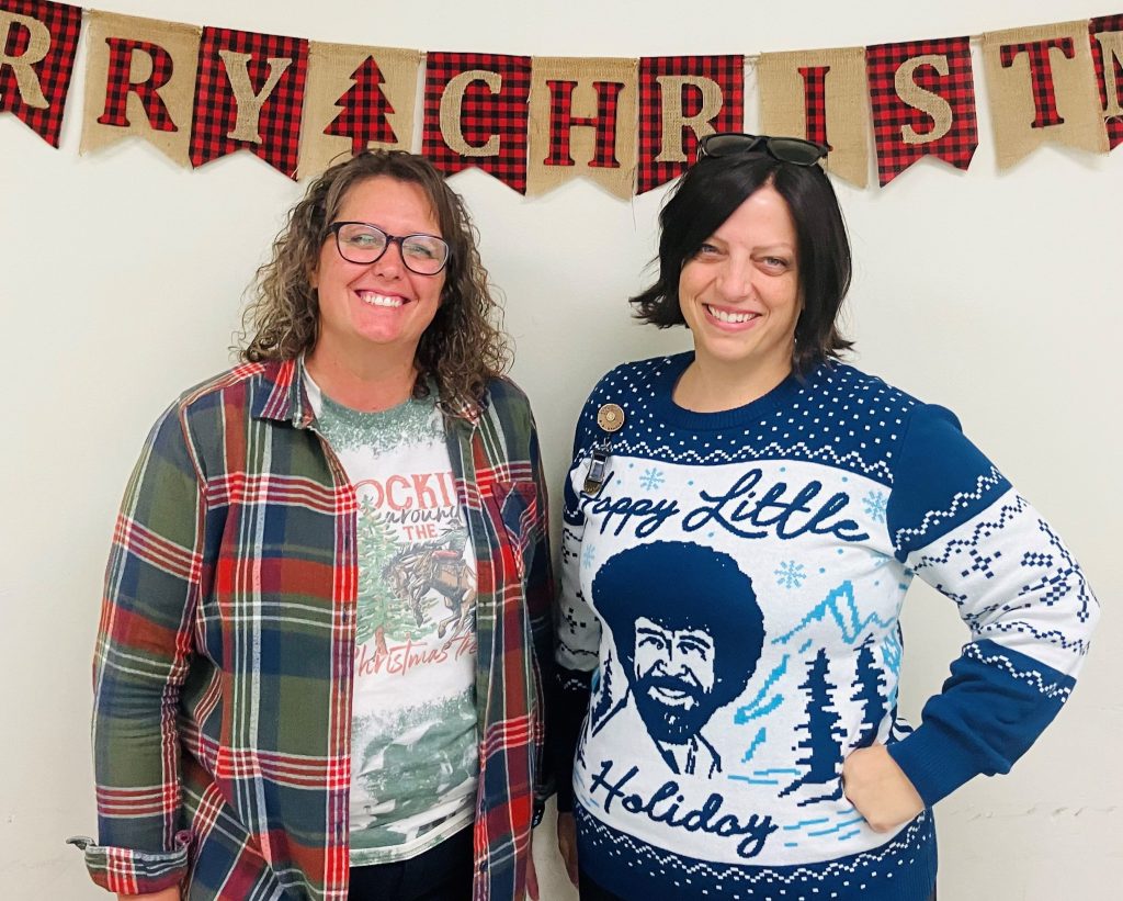 Holidays lunch celebration with two people wearing Christmas sweaters and attire.