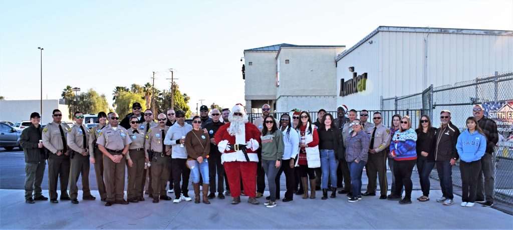 Ironwood State Prison staff with Santa at a community Civil Servants for Santa event.