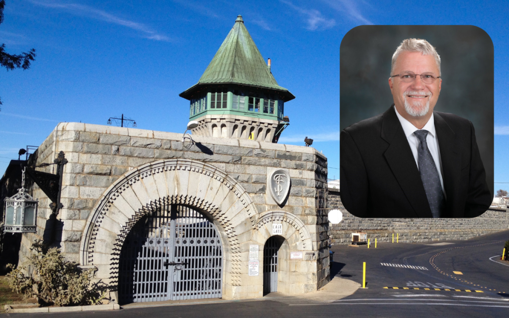 Portrait of principal Kenneth Spencer with Folsom State Prison's East Gate entrance in the background.