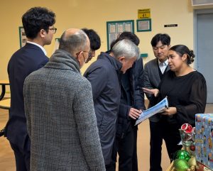 Korean delegation reviewing menu at Delancey Street