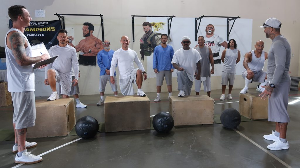 incarcerated people with coaches jumping on boxes