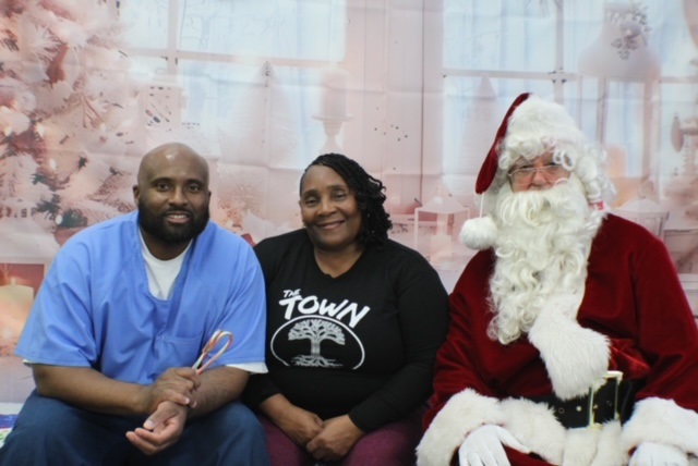 A family takes a holiday photo with Santa at Mule Creek State Prison.