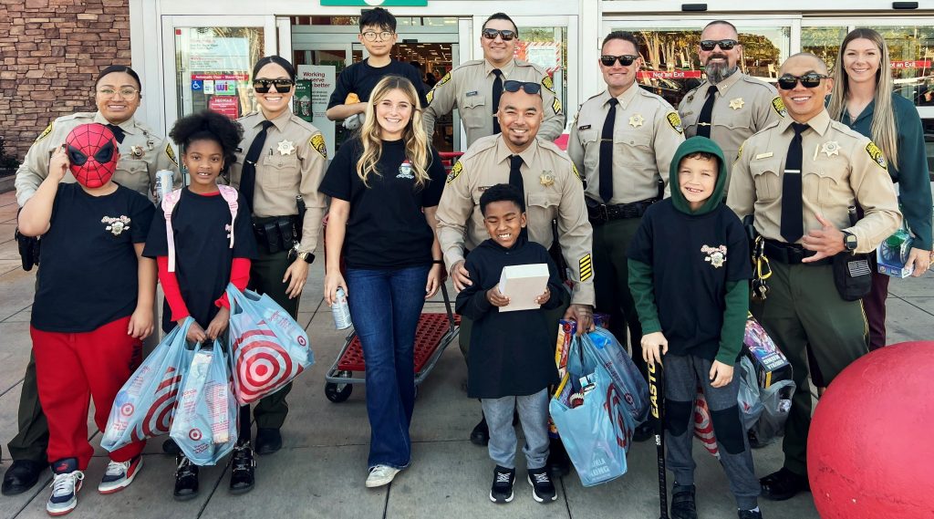 RJ Donovan Correctional Facility staff with kids at Shop with a Cop outside a Target store.