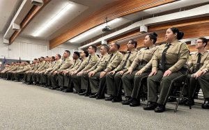 Basic Correctional Officer Academy cadets sit at the graduation ceremony in Galt.