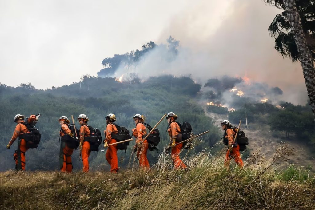 Inmate firefighters with Malibu Conservation Camp 13 respond to the Palisades Fire on Tuesday. (Caroline Brehman/EPA-EFE/Shutterstock)