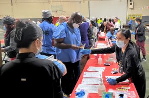 CMF health fair shows incarcerated people and medical staff at information tables.