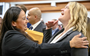 Parole Agent Wilding and another agent celebrate their academy graduation.