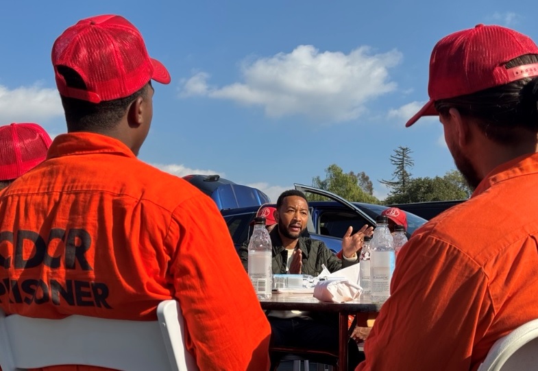 Incarcerated fire crews meet with John Legend at the Eaton fire incident command post at the Rose Bowl.