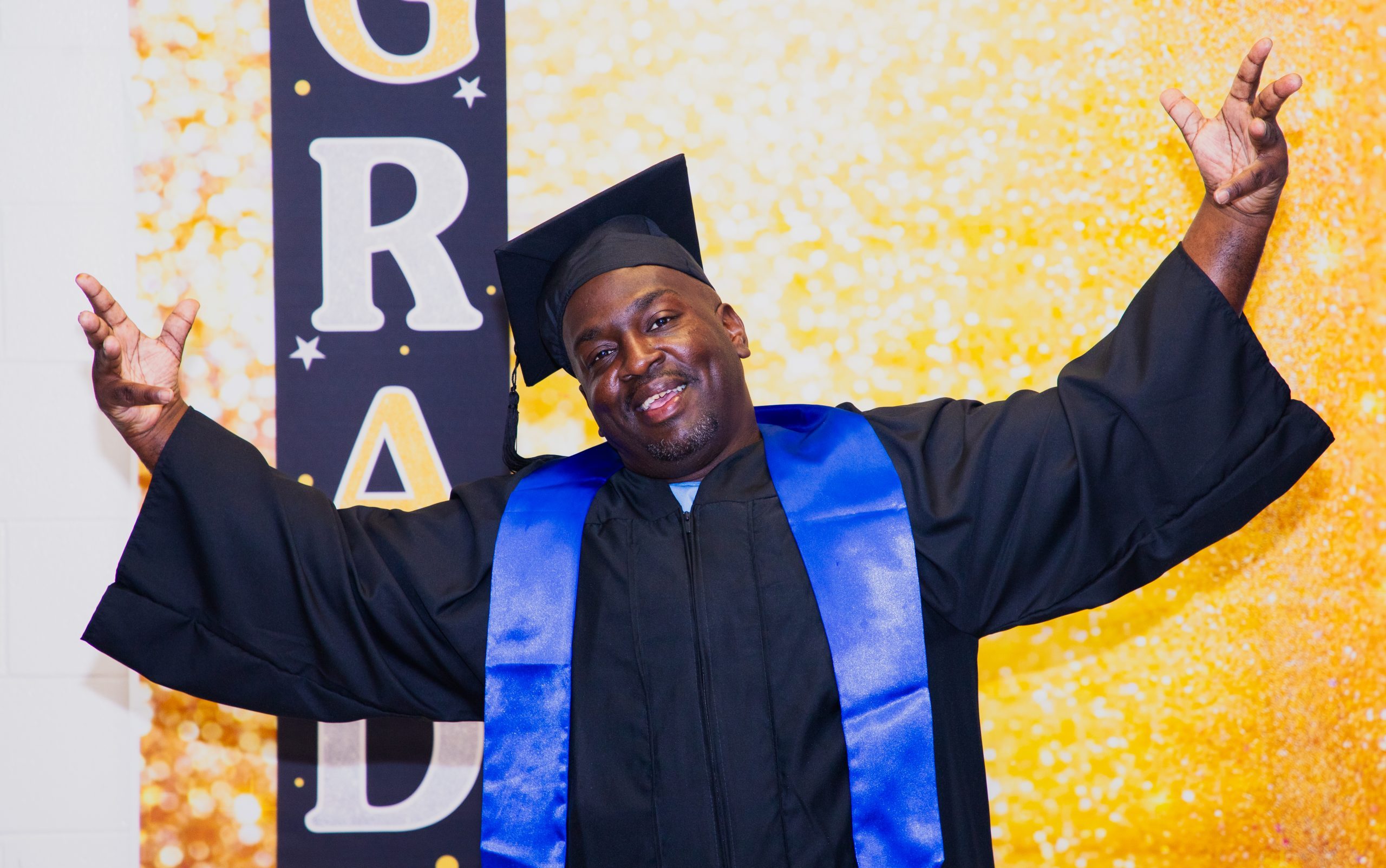 An incarcerated person celebrates their education graduation at North Kern State Prison.