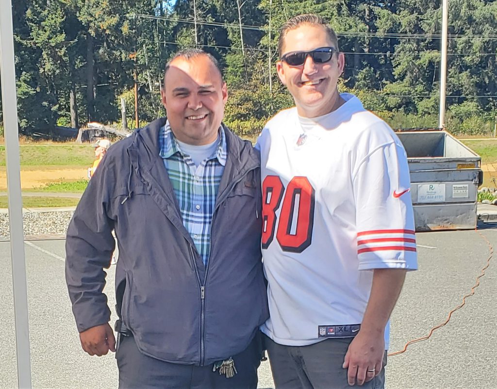 Two employees smiling at an employee appreciation day at Pelican Bay State Prison (PBSP).