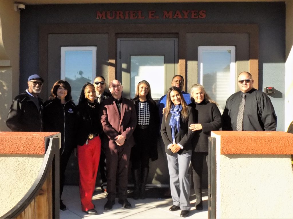 Prison staff stand in front of the Bay Area Rescue Mission. 