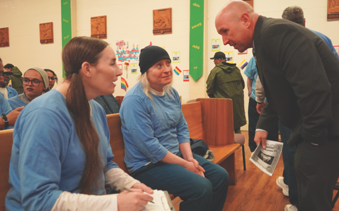 San Quentin warden speaks with two incarcerated people at the second Transgender Day of Remembrance.