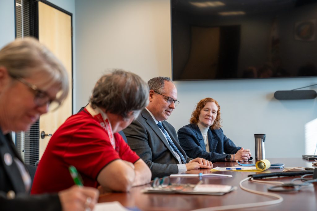 CDCR and CCHCS with Special Olympics meeting at a table.