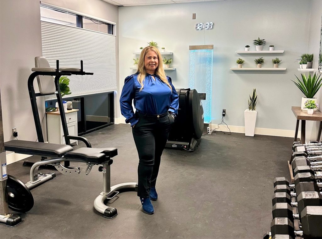 A woman stands in the middle of a wellness room at Valley State Prison.