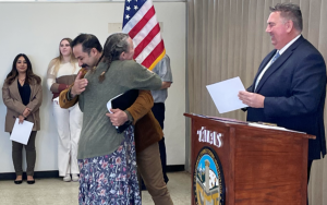 An associate warden congratulates a staff member during a CCI promotional ceremony in Tehachapi.