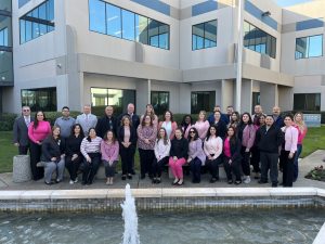 DAI, CARU group of individuals in front of an office building 