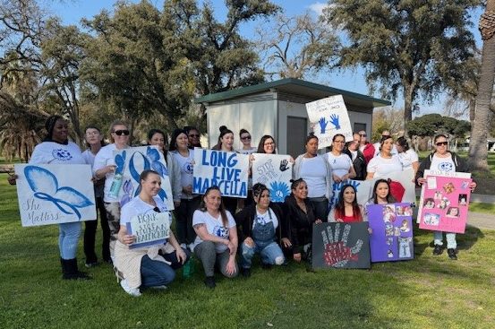 Group of women holding signs raising awareness for human tr