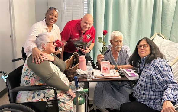 Ironwood State Prison staff present roses to people in a nursing home.