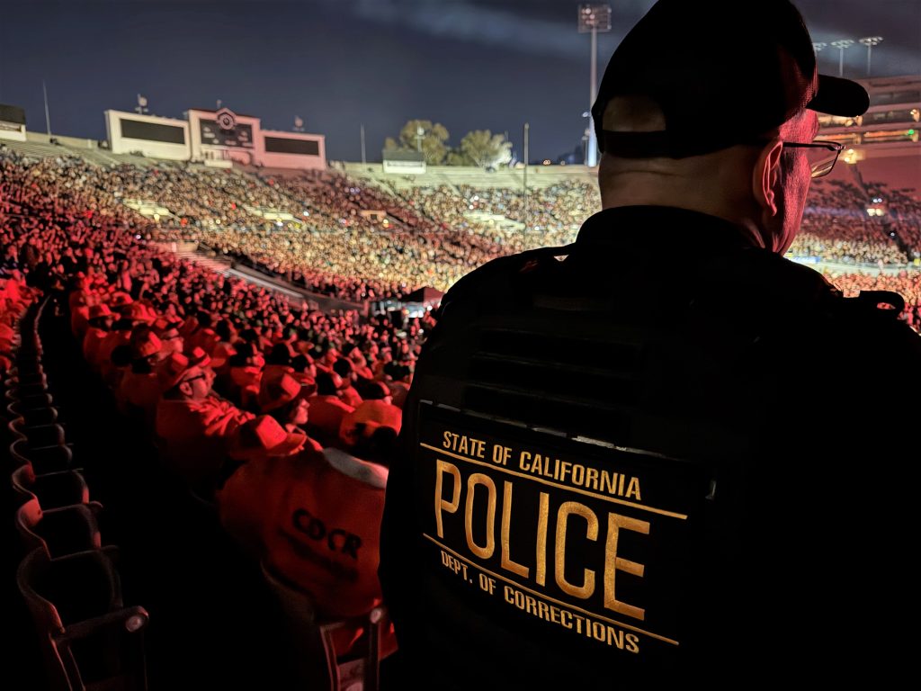 CDCR officer with incarcerated crew members watching the concert.