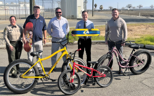 Community benefit from PVSP staff to Coalinga Chamber of Commerce with bikes and skateboard decks.