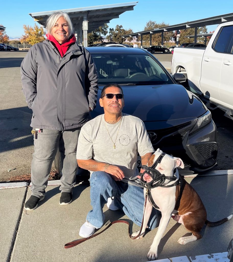 A woman and an incarcerated trainer who formed a bond with his dog at Pleasant Valley State Prison.