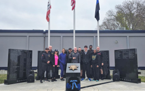 San Quentin Rehabilitation Center staff at an academy memorial listing the names of fallen police officers.