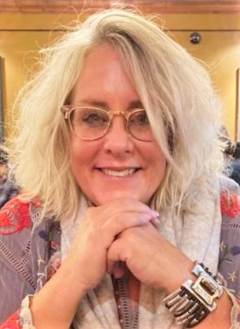 Kristin Barajas smiling with her chin resting on her hands.