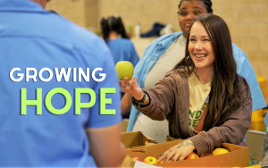 CCWF Farmers Market with the words "Growing Hope" and a woman offering an apple to an incarcerated person.