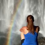 Tracy Master, PAI sitting near falls with rainbow
