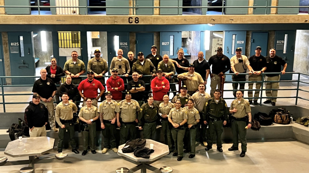 Group of Correctional Officers standing with field training sergeants at CSP-SAC 