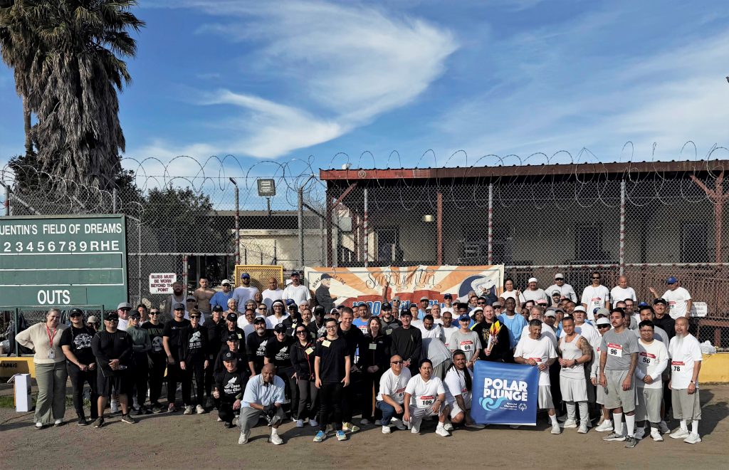 Group photo of staff, a running club, and incarcerated people at San Quentin for the Polar Plunge for Week in Review for March 7.