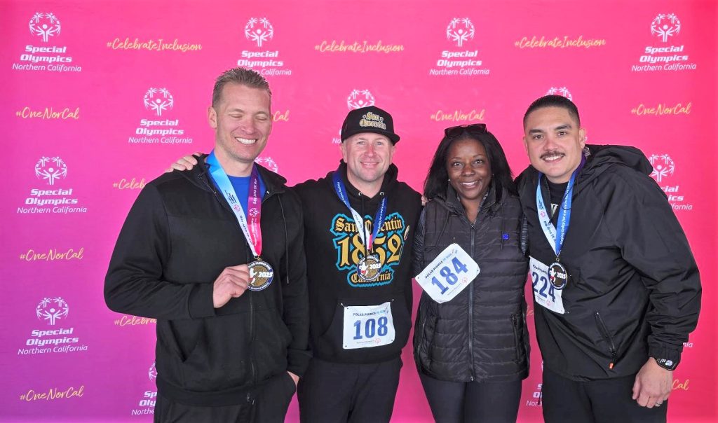 Alameda Polar Plunge for Special Olympics with athletes and San Quentin staff posing for a group photo.