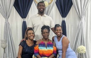 CCI Lee Walker standing with his two sisters and mother pictured in front of him