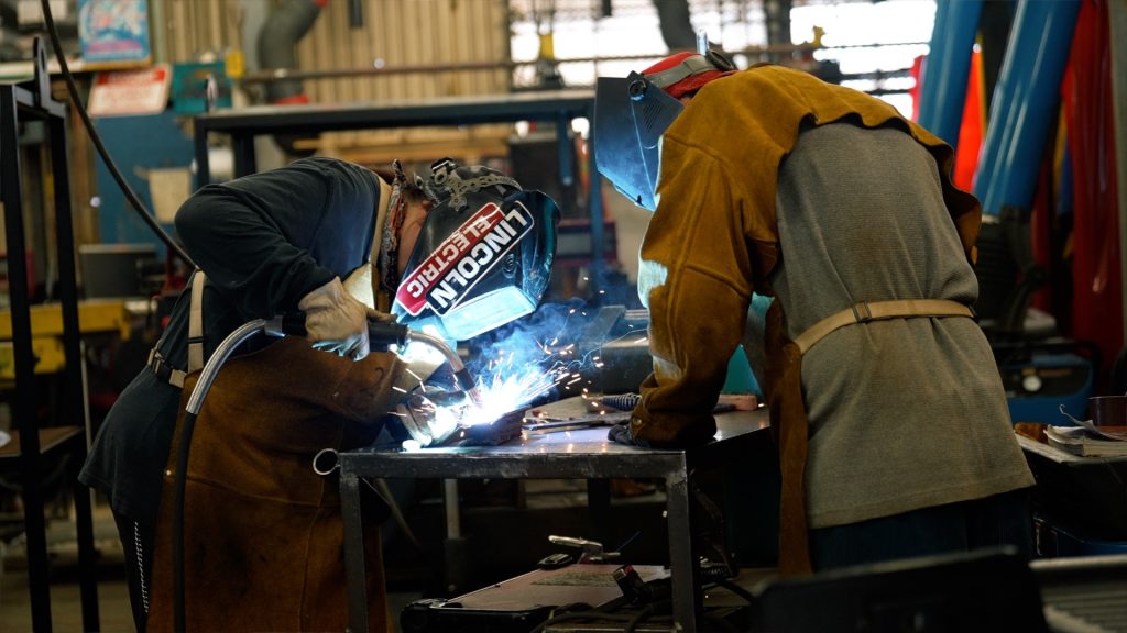 A woman welding instructor teaches an incarcerated student at the Correctional Training Facility in Soledad.