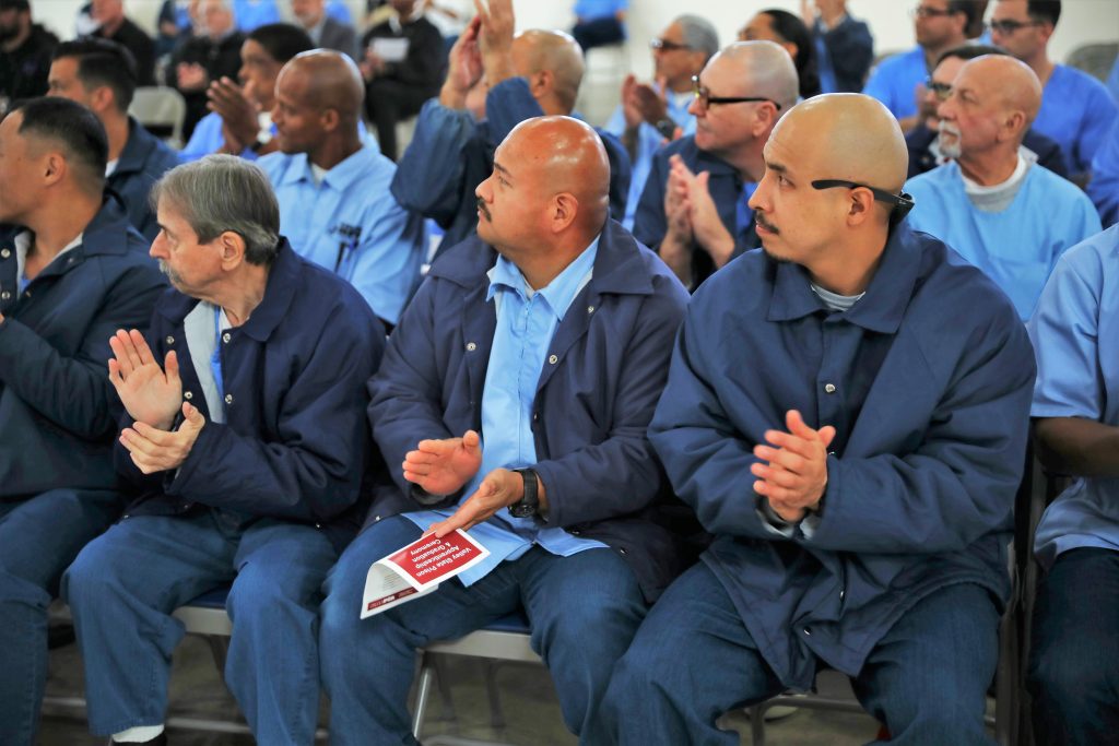 Incarcerated people cheer on fellow CALPIA graduates at Valley State Prison.