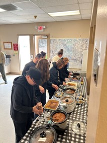 Chili cookoff table with staff serving samples