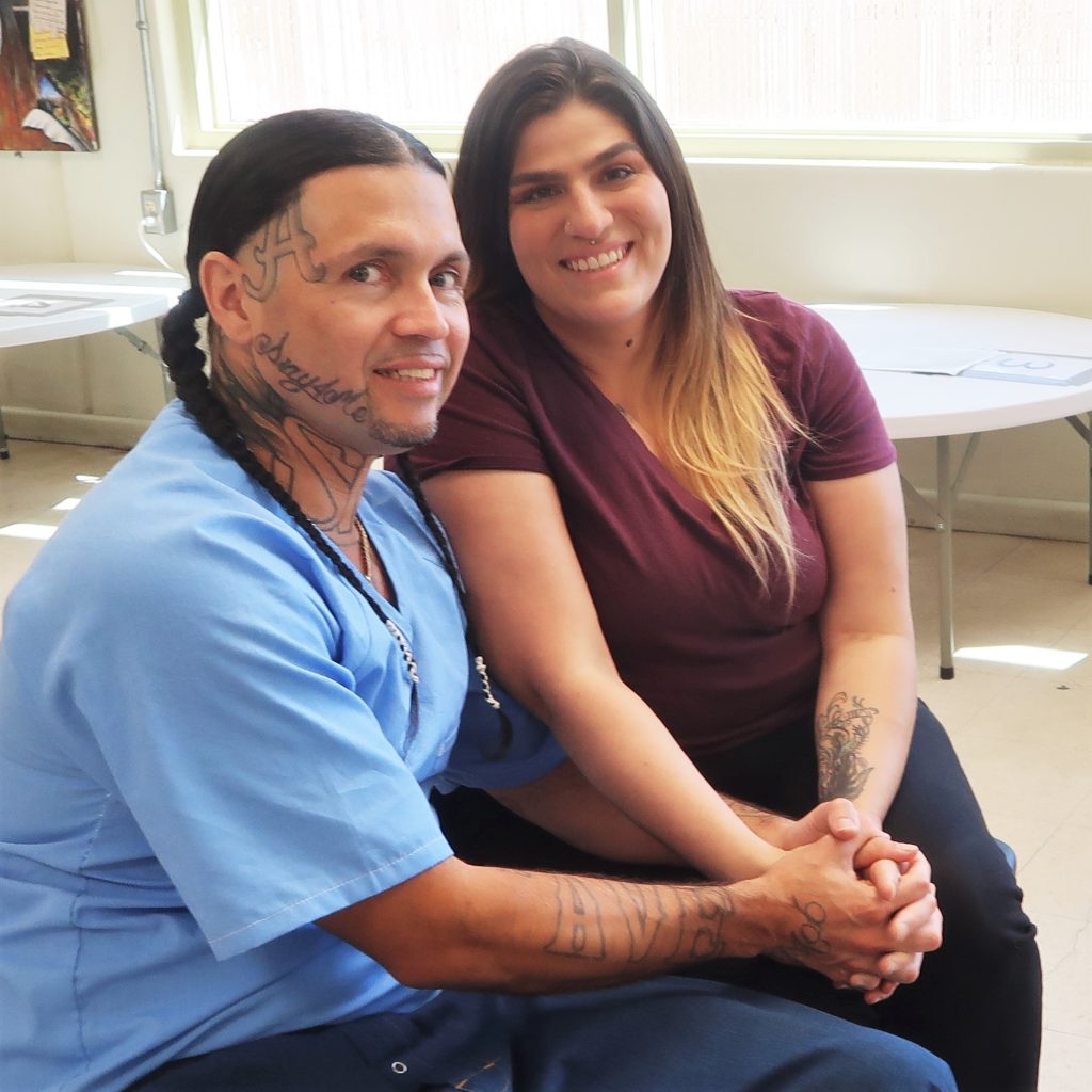An incarcerated person and a woman at Calipatria State Prison.