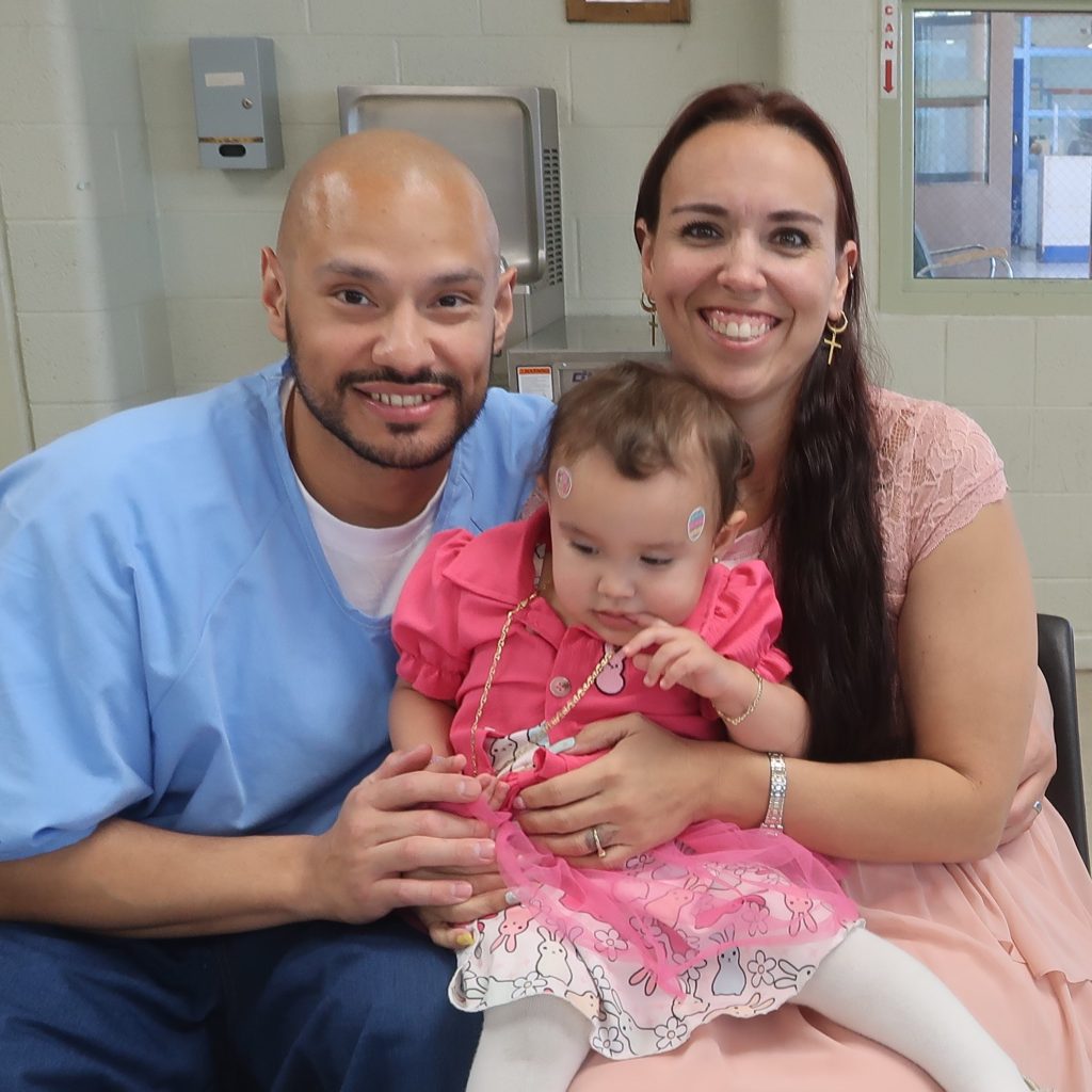 Three people at Easter family visiting at Calipatria State Prison.