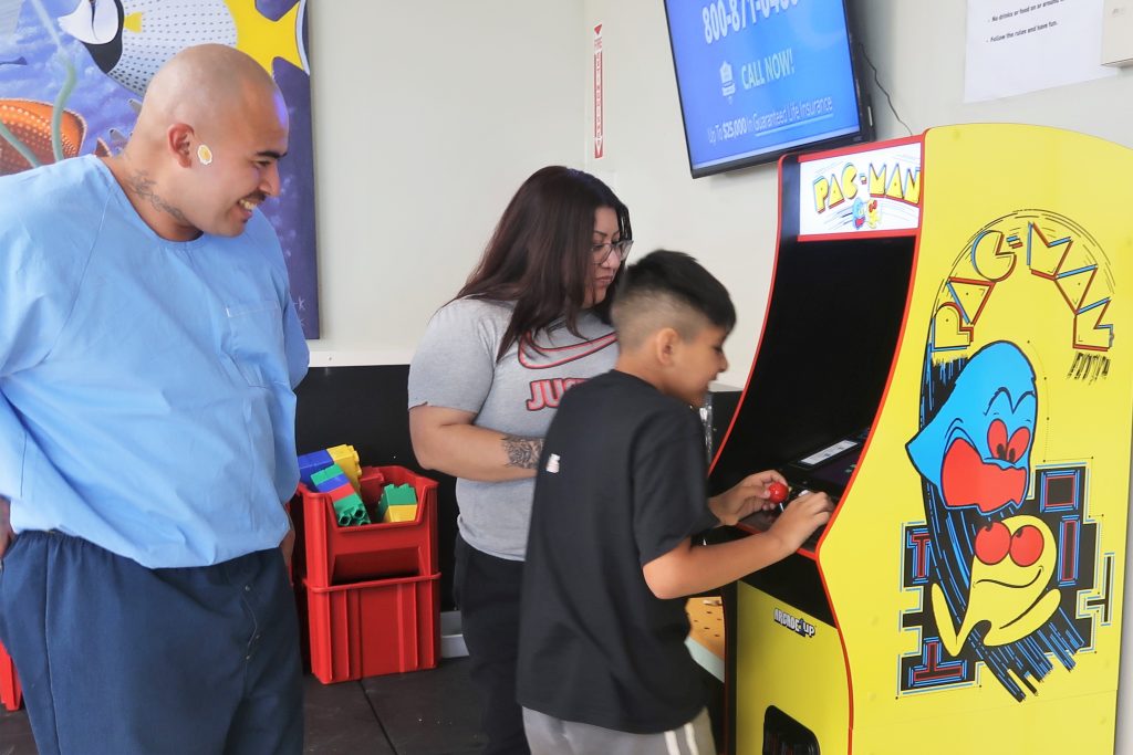 Playing video games during Easter family visiting at Calipatria State Prison. 