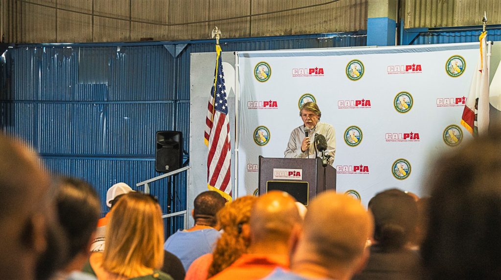 CALPIA General Manager Bill Davidson speaks to the graduates at CIM.