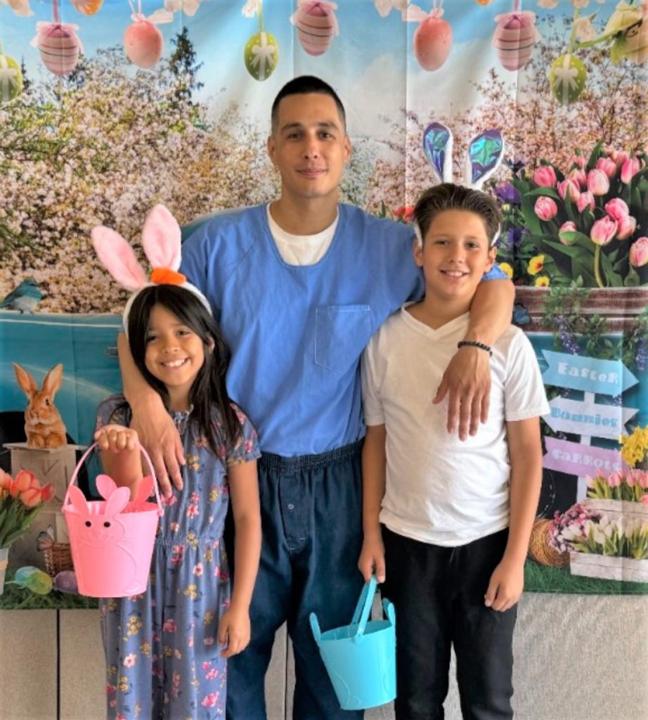 A dad with two kids at CCI Easter visiting for CDCR. 